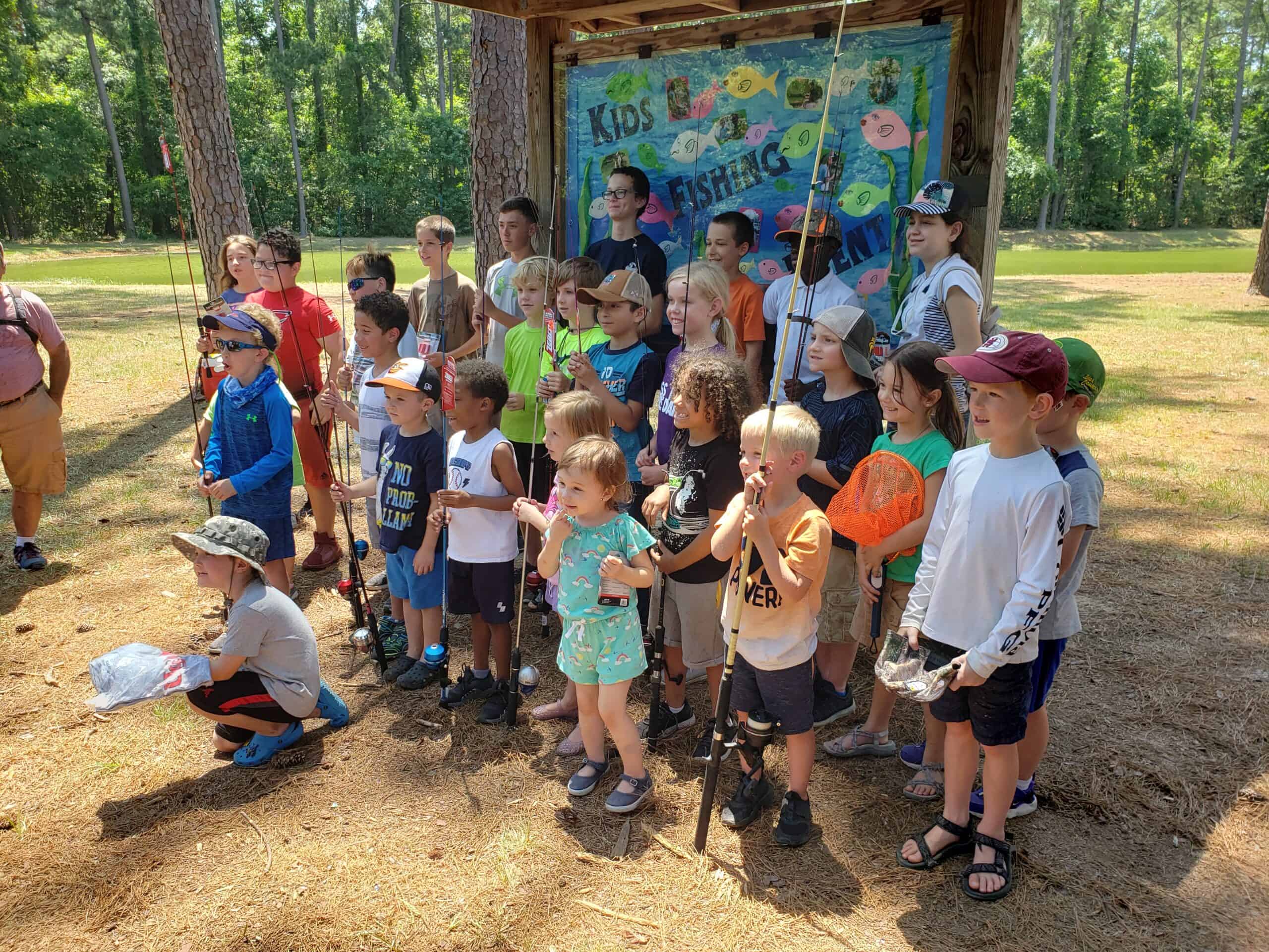 Kids fishing group pose after the day of fun