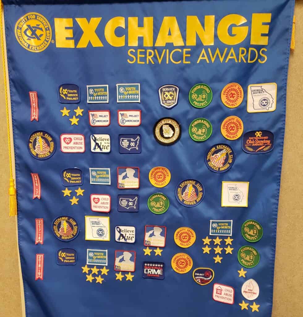 Exchange Club awards banner hangs on a wall