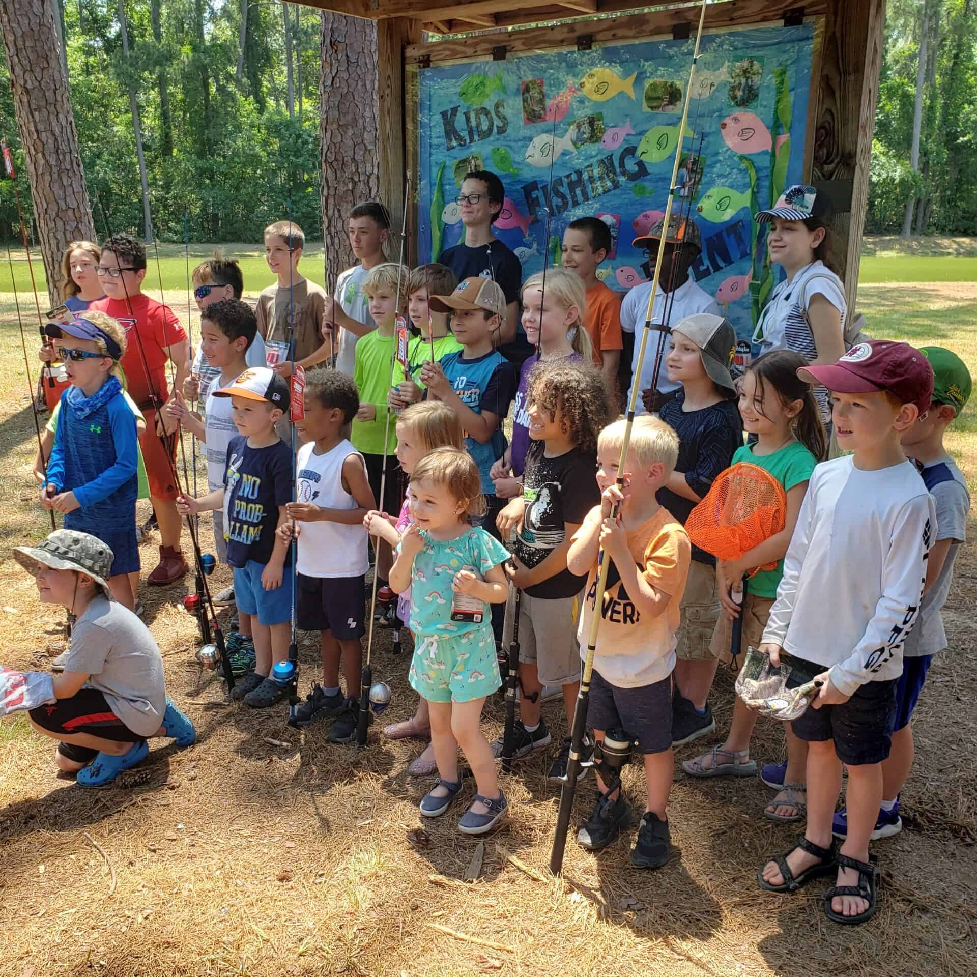 Kids fishing group pose after the day of fun