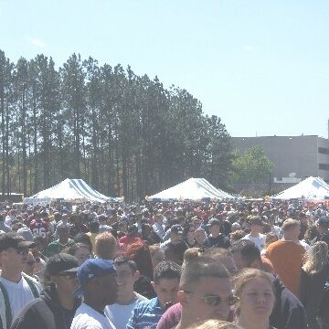 A large crowd of outdoor event attendees