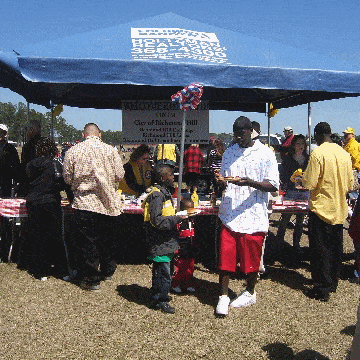 Outdoor event attendees by the hot dog tent