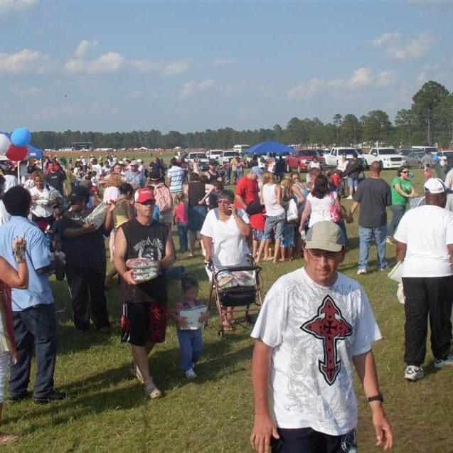 A crowd milling around at an outdoor July fourth event