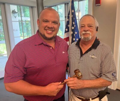 Past president poses with new president and the gavel.