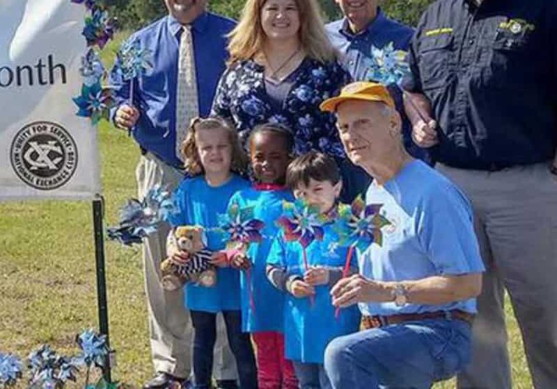 Community members with children at the Pinwheel Garden