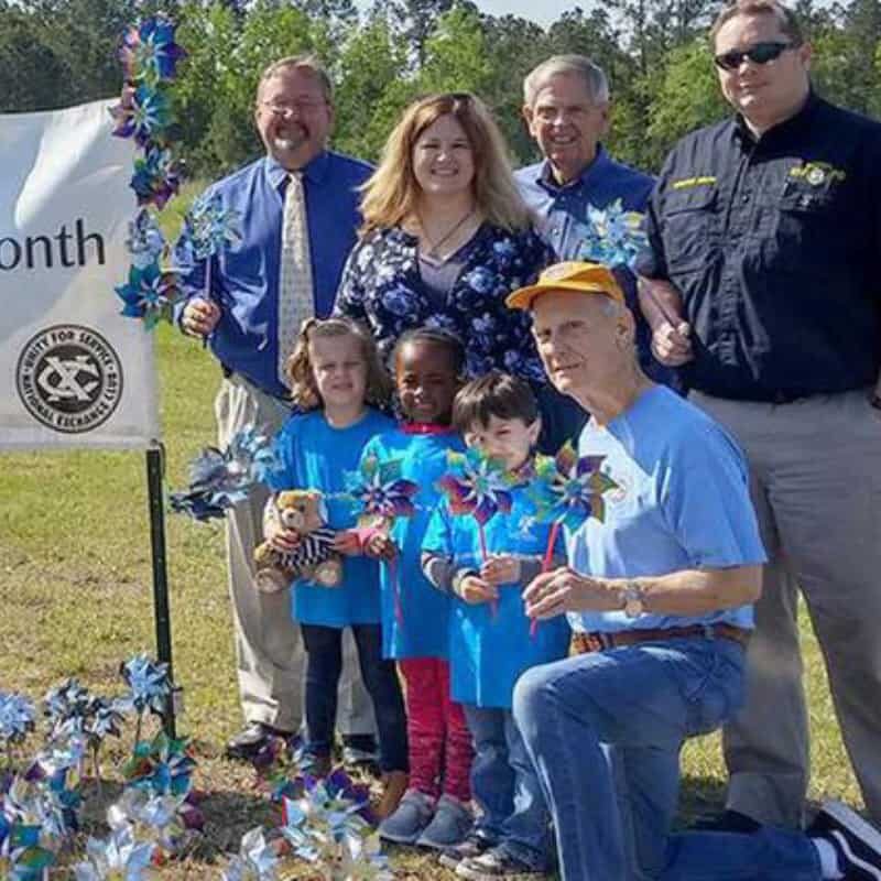 Community members with children at the Pinwheel Garden