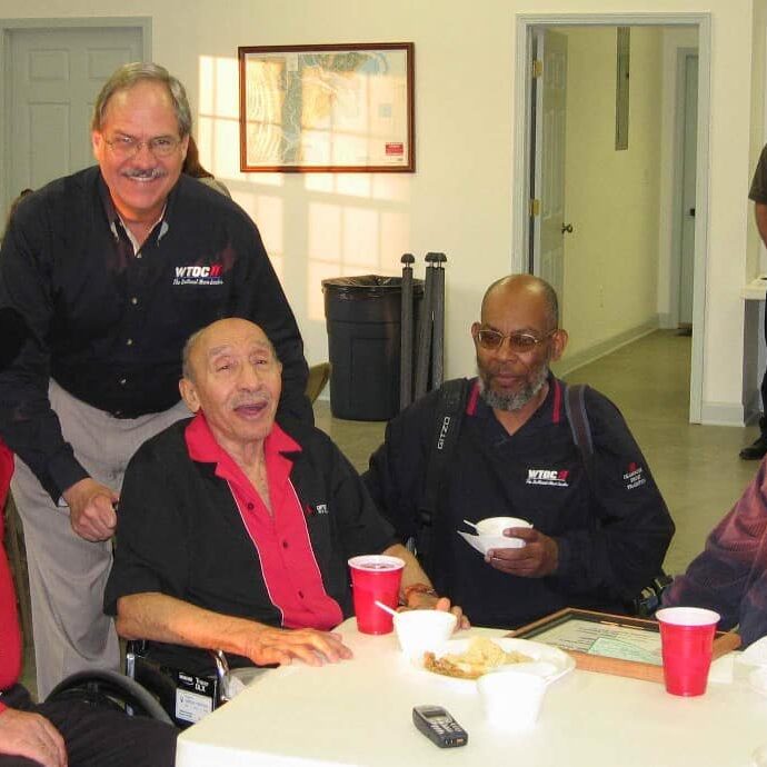 Senior men enjoying a meal together at a community center