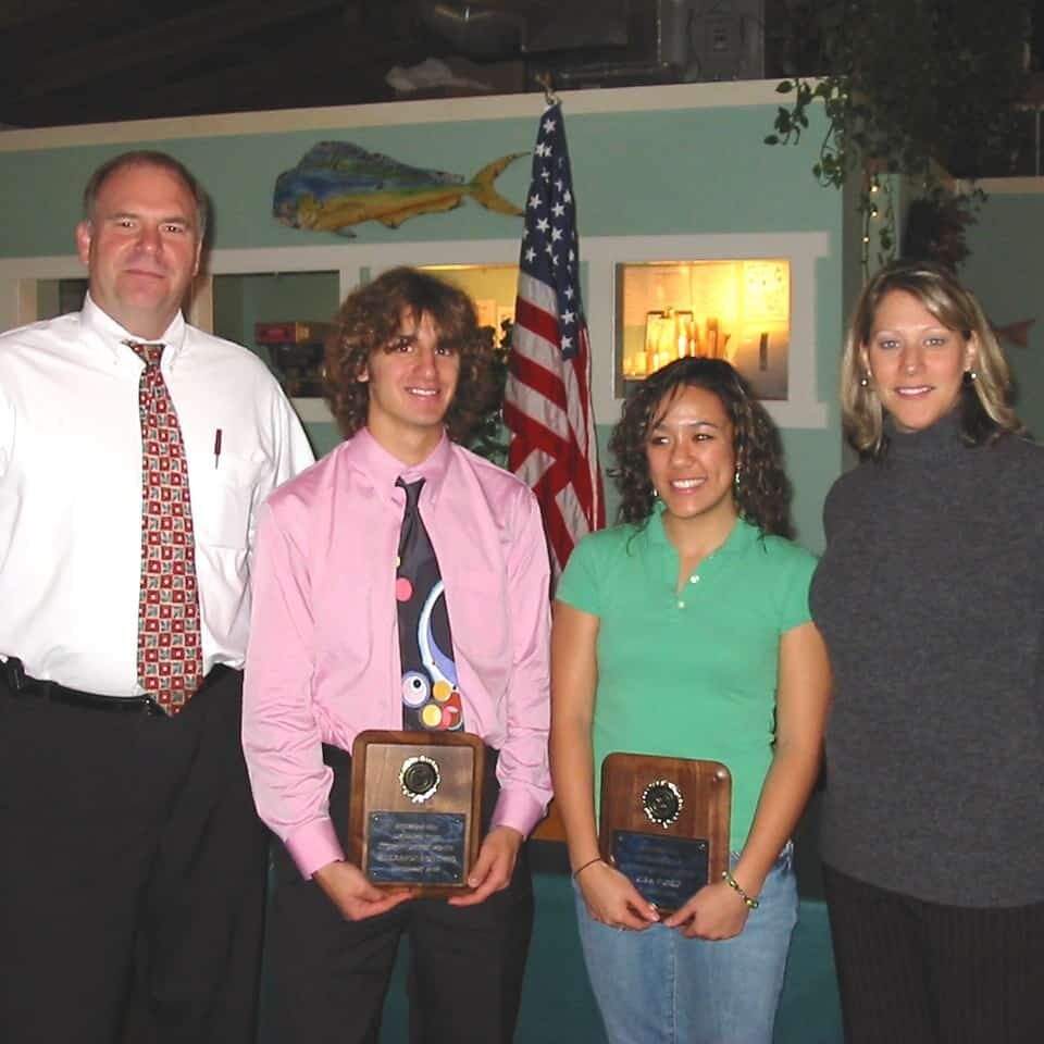 Winners of the students of the year awards pose with plaques