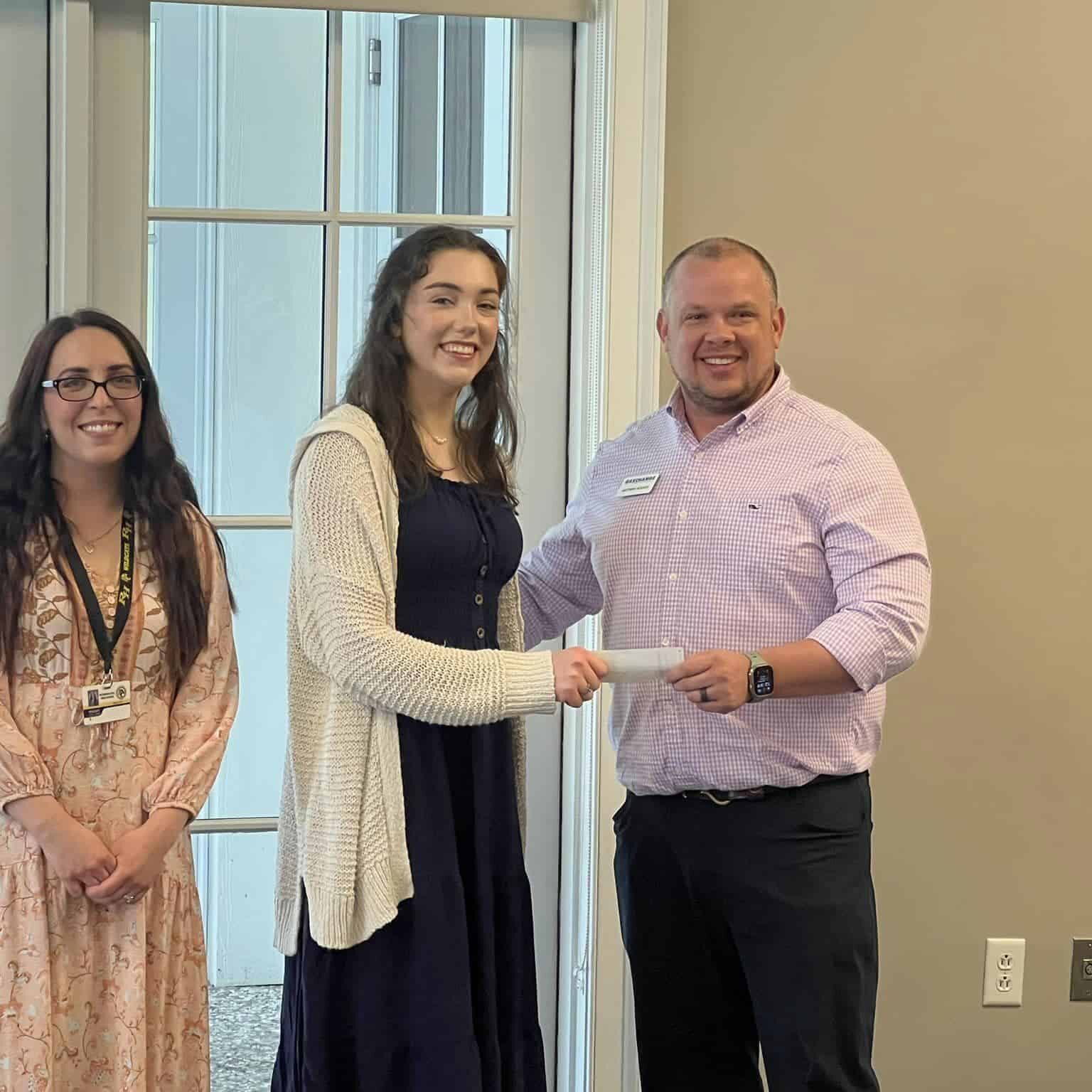 A student smiles as she receives an academic award