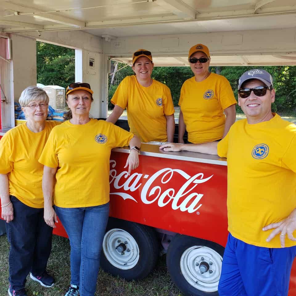 Club members pose with their Coca Cola cooler