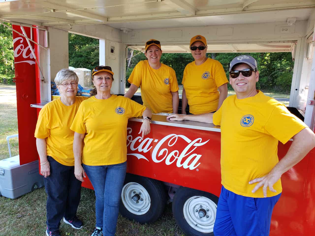 Club members pose with their Coca Cola cooler